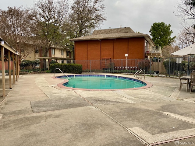 view of swimming pool with a patio