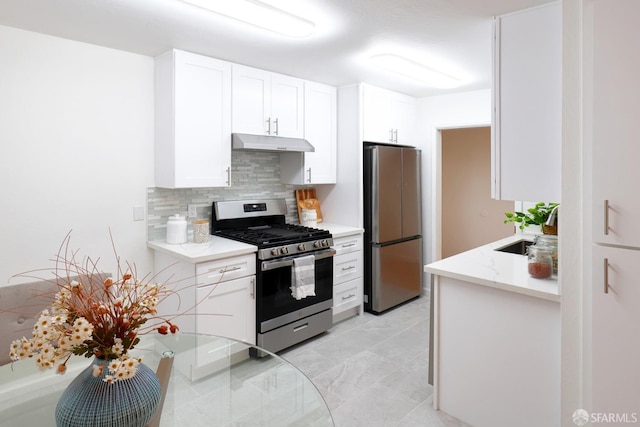 kitchen featuring stainless steel appliances, white cabinetry, tasteful backsplash, and sink