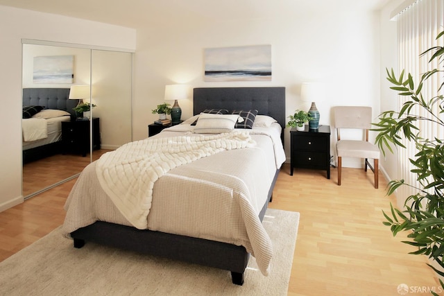 bedroom featuring light hardwood / wood-style flooring and a closet