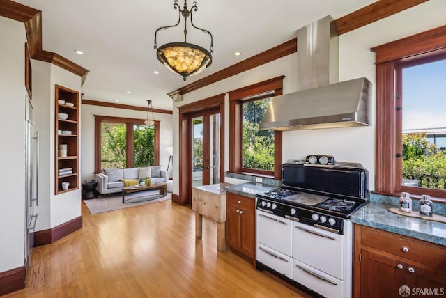 4020 20th St, San Francisco, CA 94114 - kitchen featuring wall chimney exhaust hood, white gas stove, ornamental molding, light wood-type flooring, and baseboards