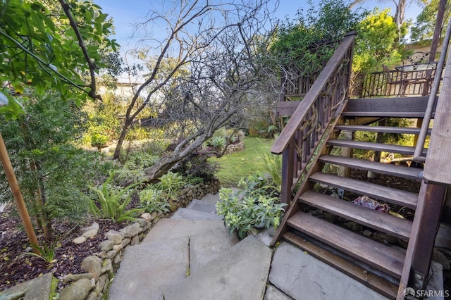 view of patio / terrace featuring stairway and fence