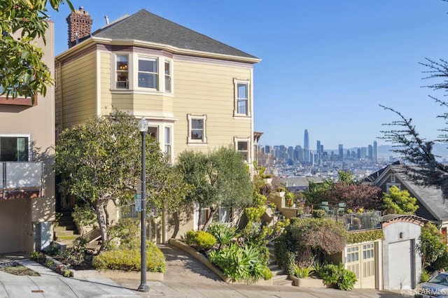 exterior space with a city view and a chimney