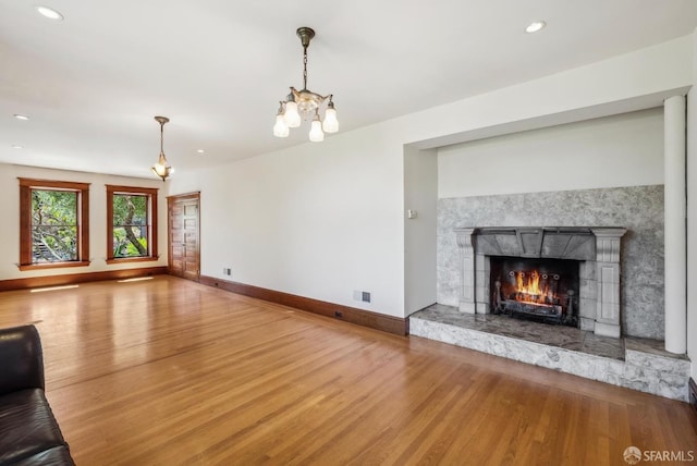 4020 20th St, San Francisco, CA 94114 - unfurnished living room with wood finished floors, a premium fireplace, baseboards, a chandelier, and recessed lighting