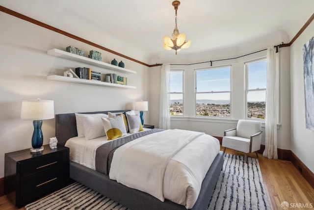 4020 20th St, San Francisco, CA 94114 - bedroom with wood finished floors, a chandelier, and baseboards