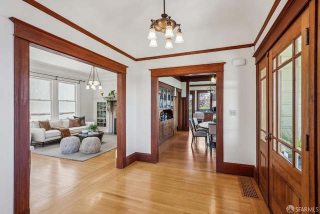 4020 20th St, San Francisco, CA 94114 - corridor featuring a chandelier, baseboards, light wood-style flooring, and crown molding