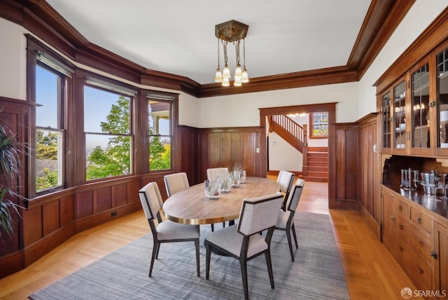 4020 20th St, San Francisco, CA 94114 - dining space with wood finished floors, stairs, crown molding, a chandelier, and wainscoting