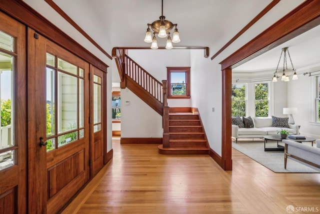 4020 20th St, San Francisco, CA 94114 - foyer with a chandelier, stairway, baseboards, and light wood-style floors