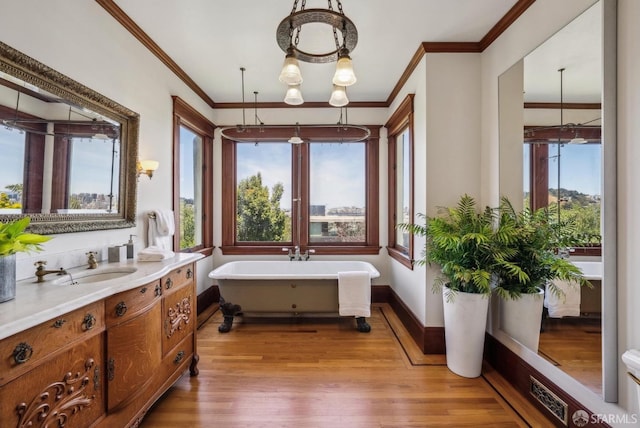 4020 20th St, San Francisco, CA 94114 - full bathroom featuring a chandelier, wood finished floors, a soaking tub, ornamental molding, and vanity