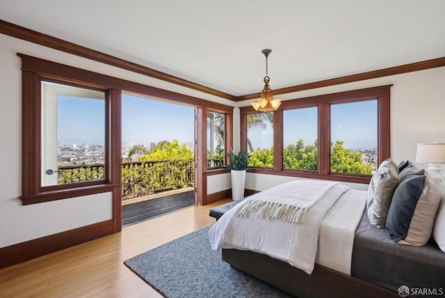 4020 20th St, San Francisco, CA 94114 - bedroom featuring access to exterior, light wood-style flooring, a chandelier, baseboards, and crown molding