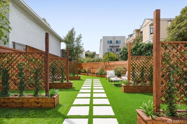 view of yard featuring fence and a vegetable garden