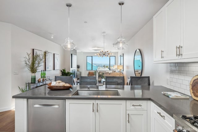 kitchen with decorative light fixtures, dishwasher, and white cabinets