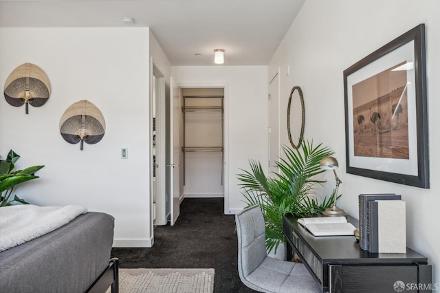 corridor featuring dark colored carpet