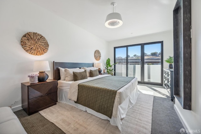 carpeted bedroom with a water view and access to outside