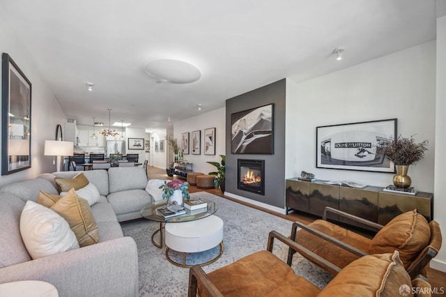 living room featuring an inviting chandelier and wood-type flooring