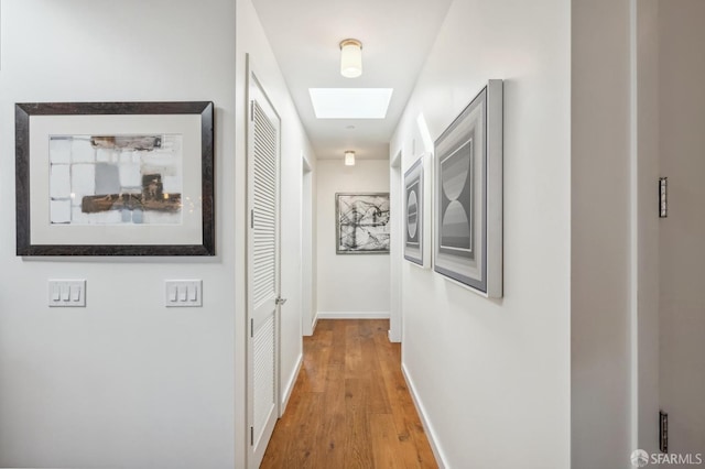 hallway with hardwood / wood-style flooring