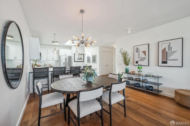 dining room featuring hardwood / wood-style floors and an inviting chandelier