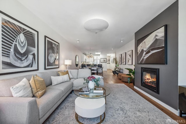 living room featuring a chandelier and hardwood / wood-style floors