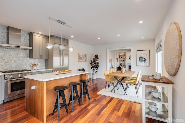 20 Marietta Dr, San Francisco, CA 94127 - kitchen featuring stainless steel range, wall chimney range hood, gray cabinets, light countertops, and a kitchen breakfast bar