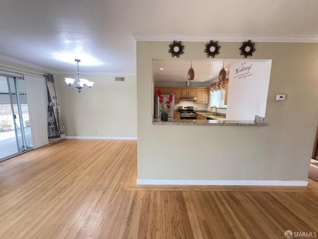 kitchen with visible vents, ornamental molding, stainless steel appliances, under cabinet range hood, and a sink