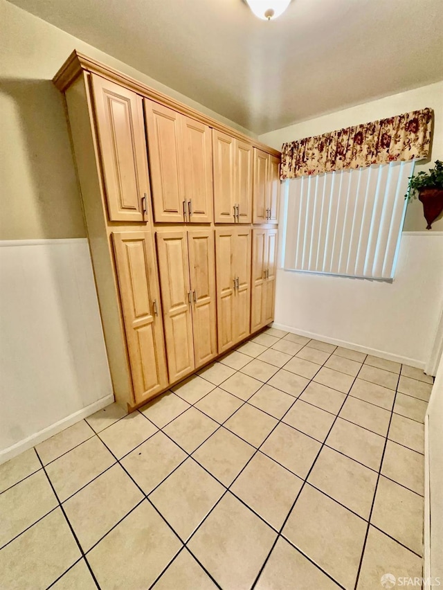 kitchen featuring light brown cabinetry and light tile patterned flooring