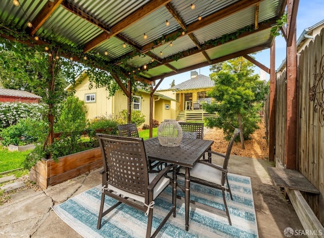 view of patio / terrace with a garden and outdoor dining area