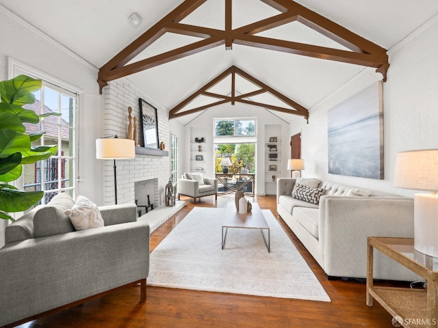 living area featuring a wealth of natural light, a fireplace, lofted ceiling, and wood finished floors