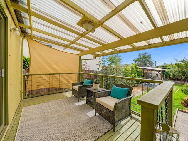 wooden deck featuring a pergola and an outdoor hangout area