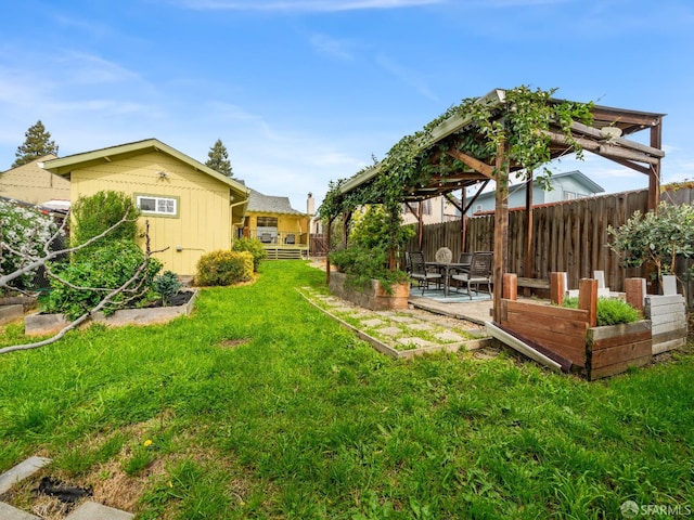 view of yard with a garden, fence, a gazebo, and a patio