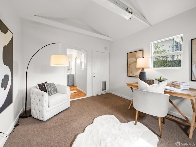 carpeted home office with lofted ceiling and baseboards