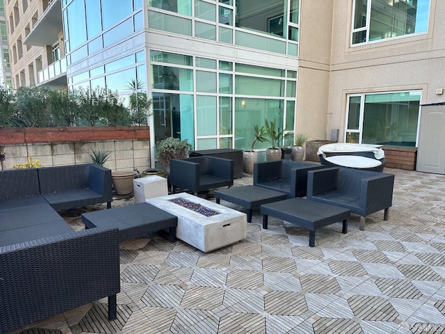 view of patio / terrace with an outdoor living space with a fire pit