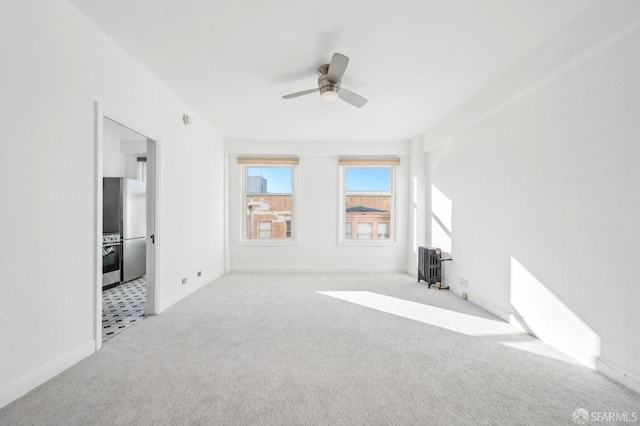 interior space featuring light carpet and ceiling fan