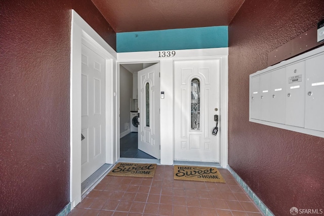 property entrance featuring washer / dryer