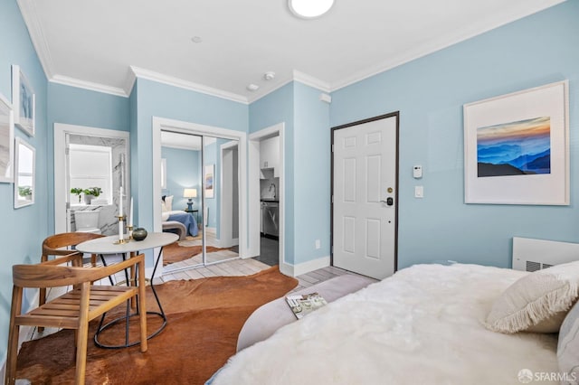 bedroom with ornamental molding, a closet, and light wood-type flooring