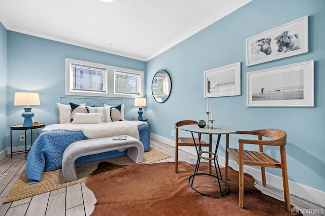 bedroom with crown molding and hardwood / wood-style flooring