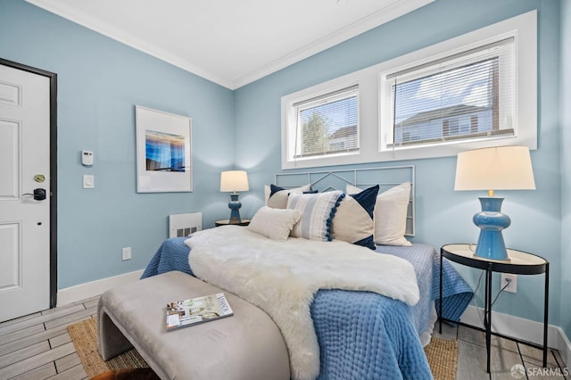 bedroom with hardwood / wood-style flooring and crown molding