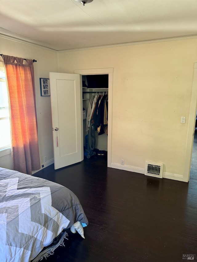 bedroom featuring dark hardwood / wood-style flooring and a closet