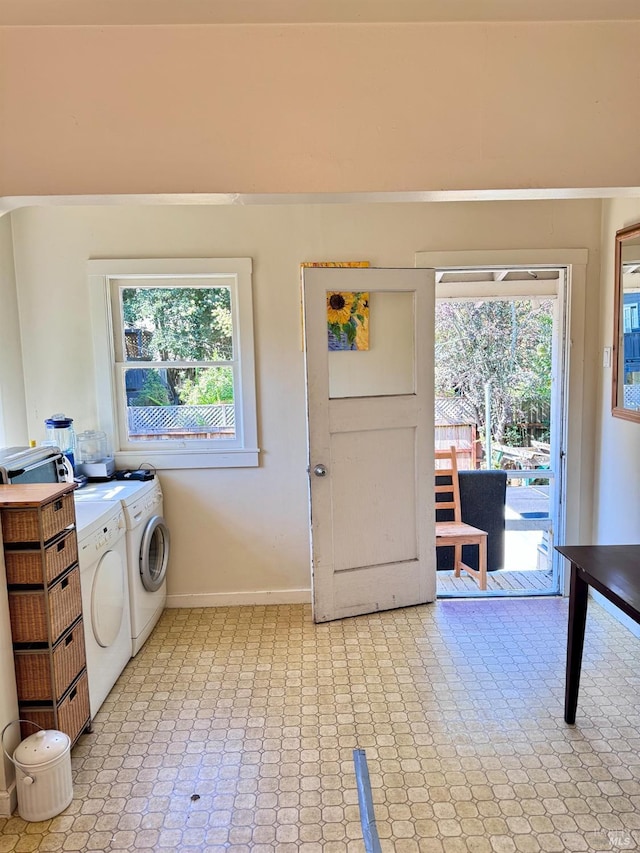 clothes washing area featuring washer and clothes dryer