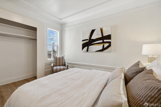 bedroom with a closet and hardwood / wood-style flooring