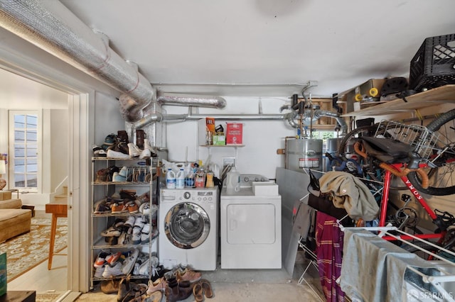 laundry room with independent washer and dryer and water heater