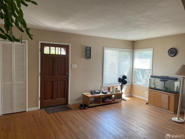 21723 Ada St, Castro Valley, CA 94546 - foyer with a textured wall, baseboards, wood finished floors, and a textured ceiling