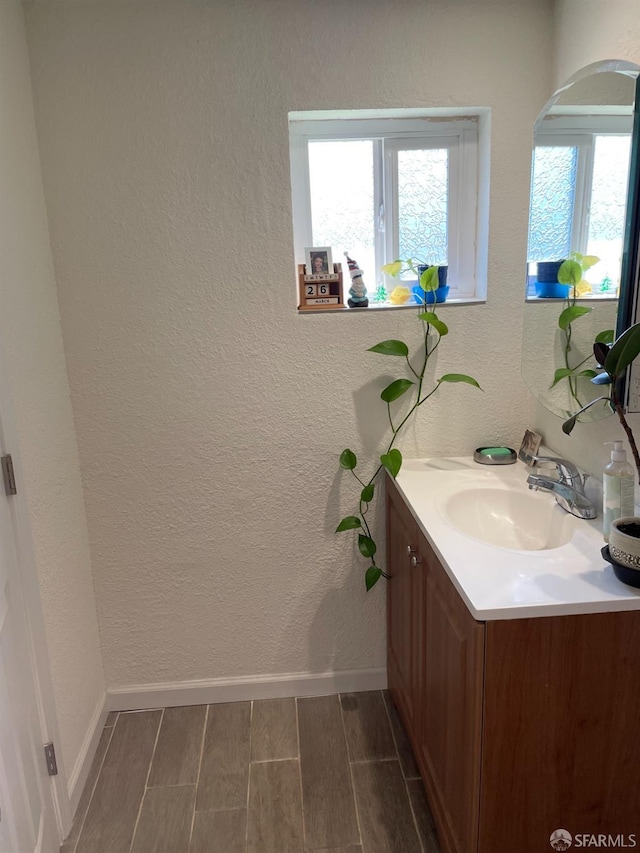 21723 Ada St, Castro Valley, CA 94546 - bathroom with baseboards, a textured wall, vanity, and wood finish floors
