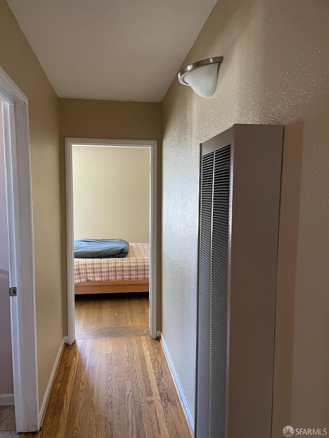 21723 Ada St, Castro Valley, CA 94546 - corridor with a textured wall, baseboards, wood finished floors, and a heating unit