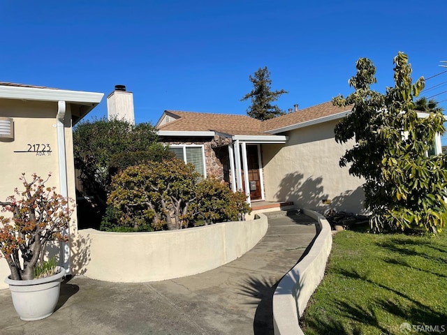 21723 Ada St, Castro Valley, CA 94546 - view of front facade featuring stucco siding, stone siding, and a chimney