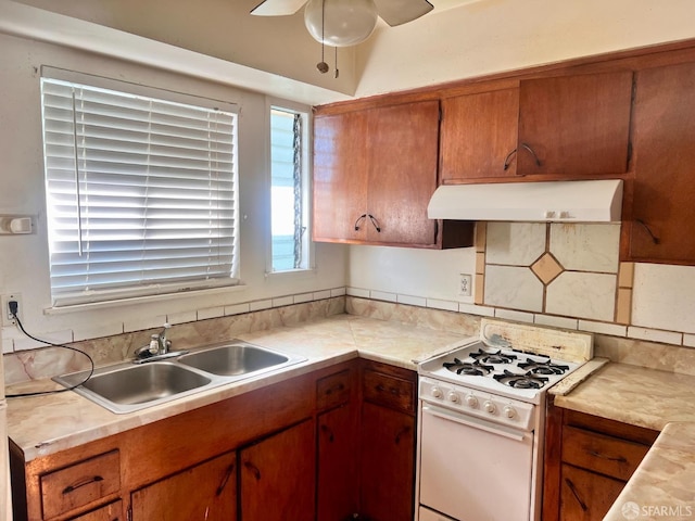 933 41st St, Oakland, CA 94608 - kitchen with ceiling fan, a sink, light countertops, gas range gas stove, and under cabinet range hood