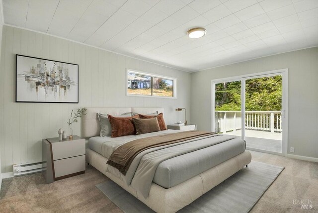 1685 Bay Flat Rd, Bodega Bay, CA 94923 - bedroom featuring carpet flooring, access to exterior, a baseboard heating unit, baseboards, and wood walls