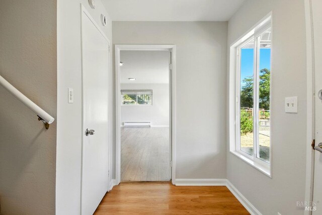 1685 Bay Flat Rd, Bodega Bay, CA 94923 - corridor with light wood finished floors, baseboards, and a baseboard radiator