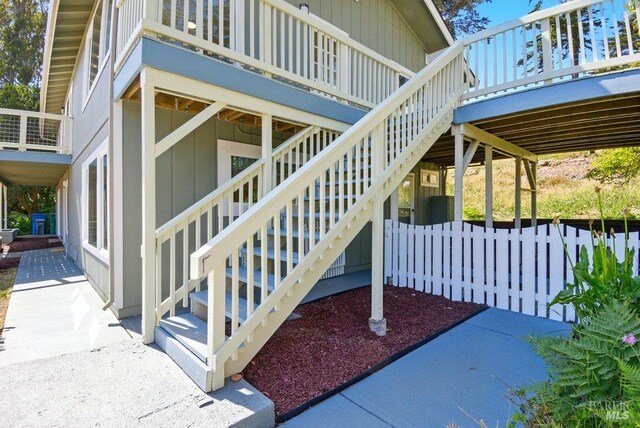 1685 Bay Flat Rd, Bodega Bay, CA 94923 - property entrance with a wooden deck and board and batten siding
