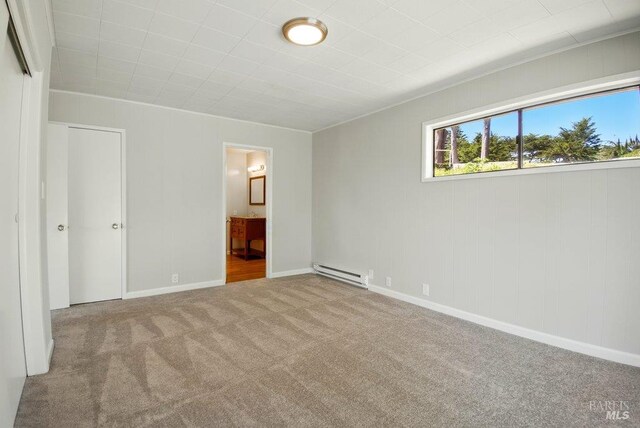 1685 Bay Flat Rd, Bodega Bay, CA 94923 - unfurnished bedroom with a baseboard radiator, carpet, connected bathroom, and baseboards