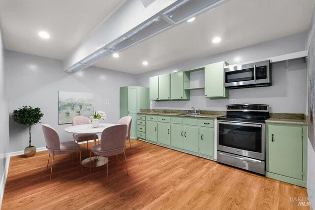 1685 Bay Flat Rd, Bodega Bay, CA 94923 - kitchen with green cabinets, appliances with stainless steel finishes, light wood-style flooring, baseboards, and recessed lighting