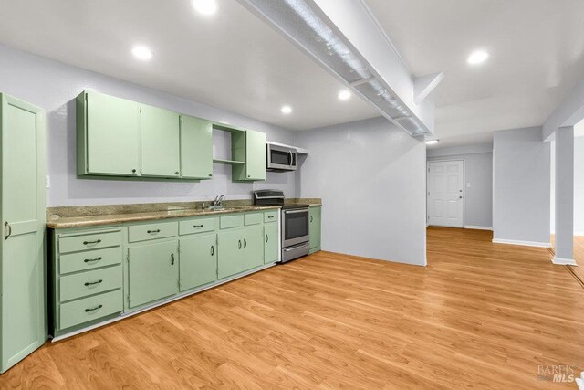 1685 Bay Flat Rd, Bodega Bay, CA 94923 - kitchen with appliances with stainless steel finishes, green cabinetry, a sink, light wood-style floors, and recessed lighting